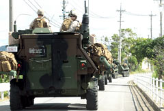 U.S. military vehicles enter restricted road