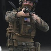U.S. soldier points muzzle of his gun toward Ryukyu Shimpo reporter during training at Naha Port